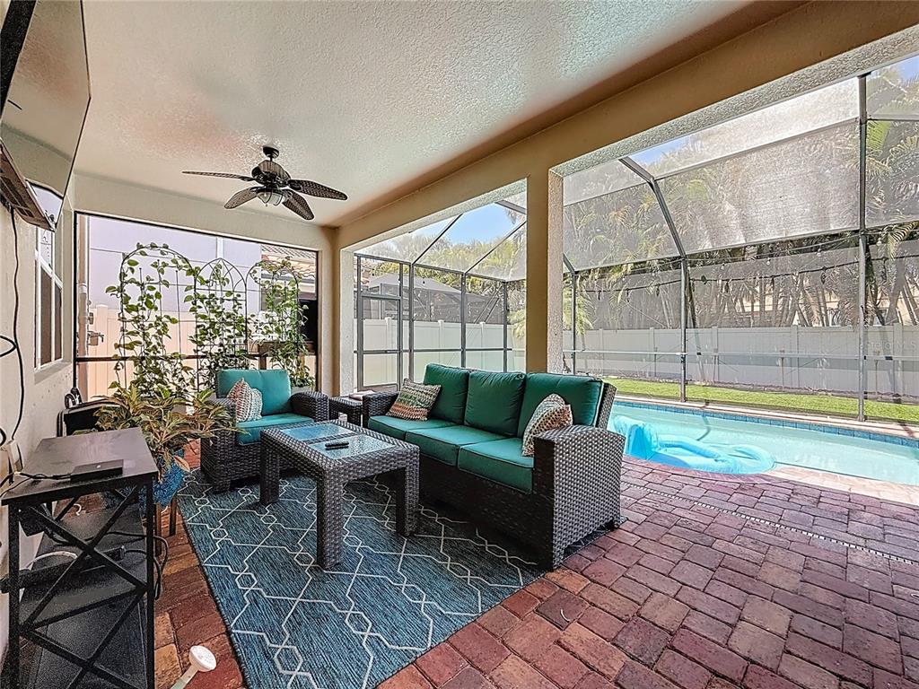 10193 Grand Oak Circle Madeira Beach, FL 33708 - Photo 54 of 67 a living room with furniture and a floor to ceiling window