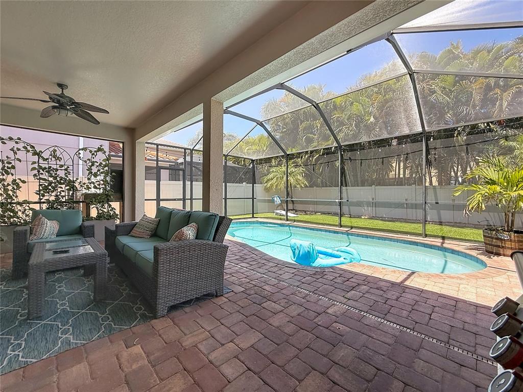 10193 Grand Oak Circle Madeira Beach, FL 33708 - Photo 55 of 67 a living room with couch and floor to ceiling windows