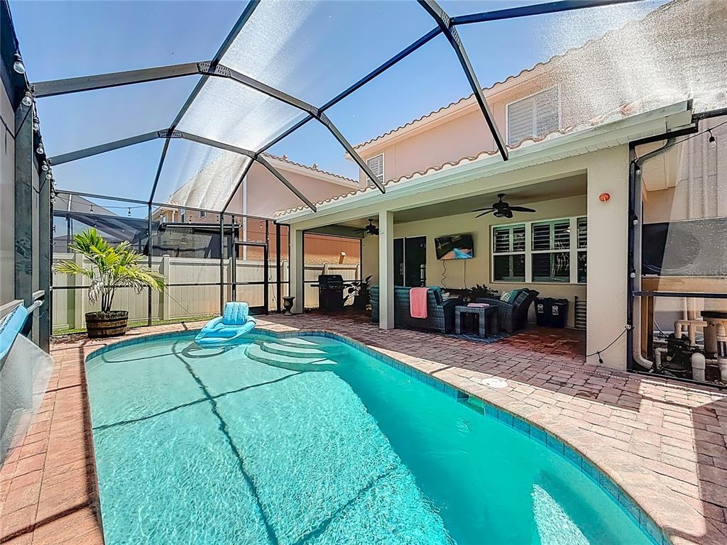 10193 Grand Oak Circle Madeira Beach, FL 33708 - Photo 59 of 67 a view of a patio with table and chairs under an umbrella