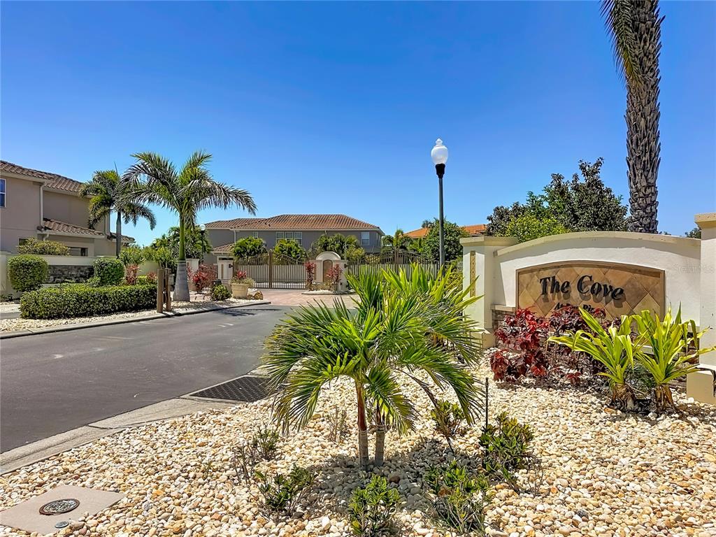 10193 Grand Oak Circle Madeira Beach, FL 33708 - Photo 66 of 67 a front view of a house with a garden