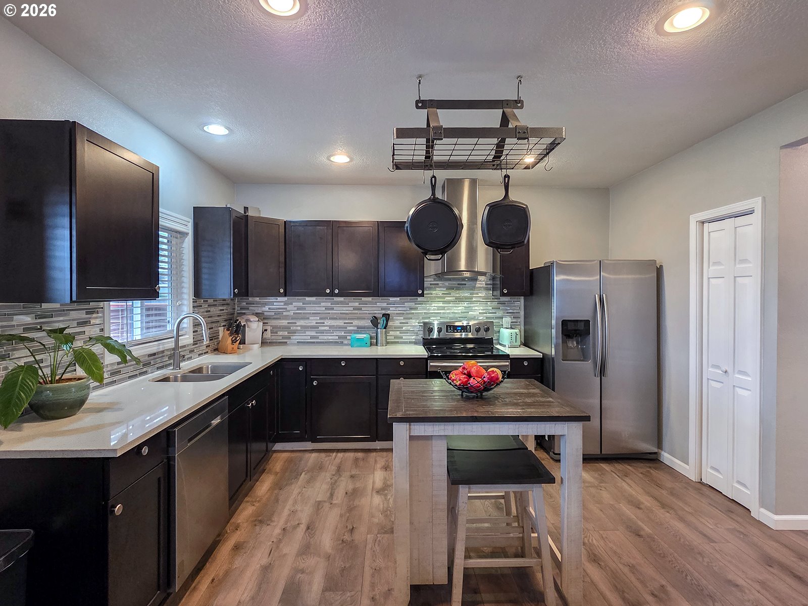 1214 North Clark Street Cornelius, OR 97113 - Photo 12 of 34 a kitchen with stainless steel appliances a sink stove and refrigerator
