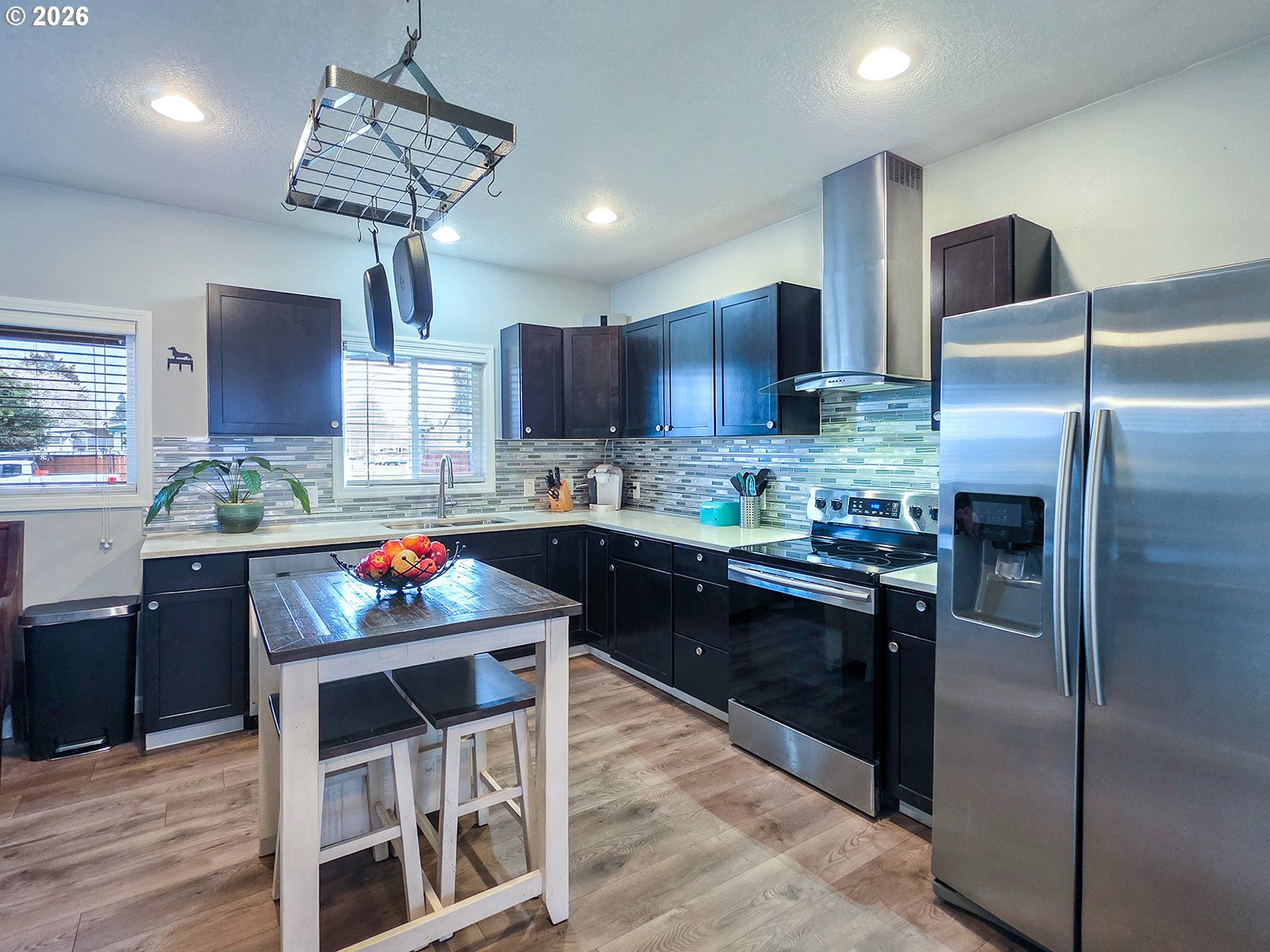 1214 North Clark Street Cornelius, OR 97113 - Photo 13 of 34 a kitchen with stainless steel appliances granite countertop a refrigerator a stove a sink dishwasher a oven with a dining table and chairs