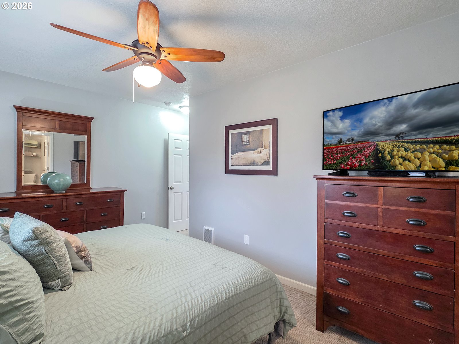 1214 North Clark Street Cornelius, OR 97113 - Photo 18 of 34 a bedroom with a bed and a mirror on dresser