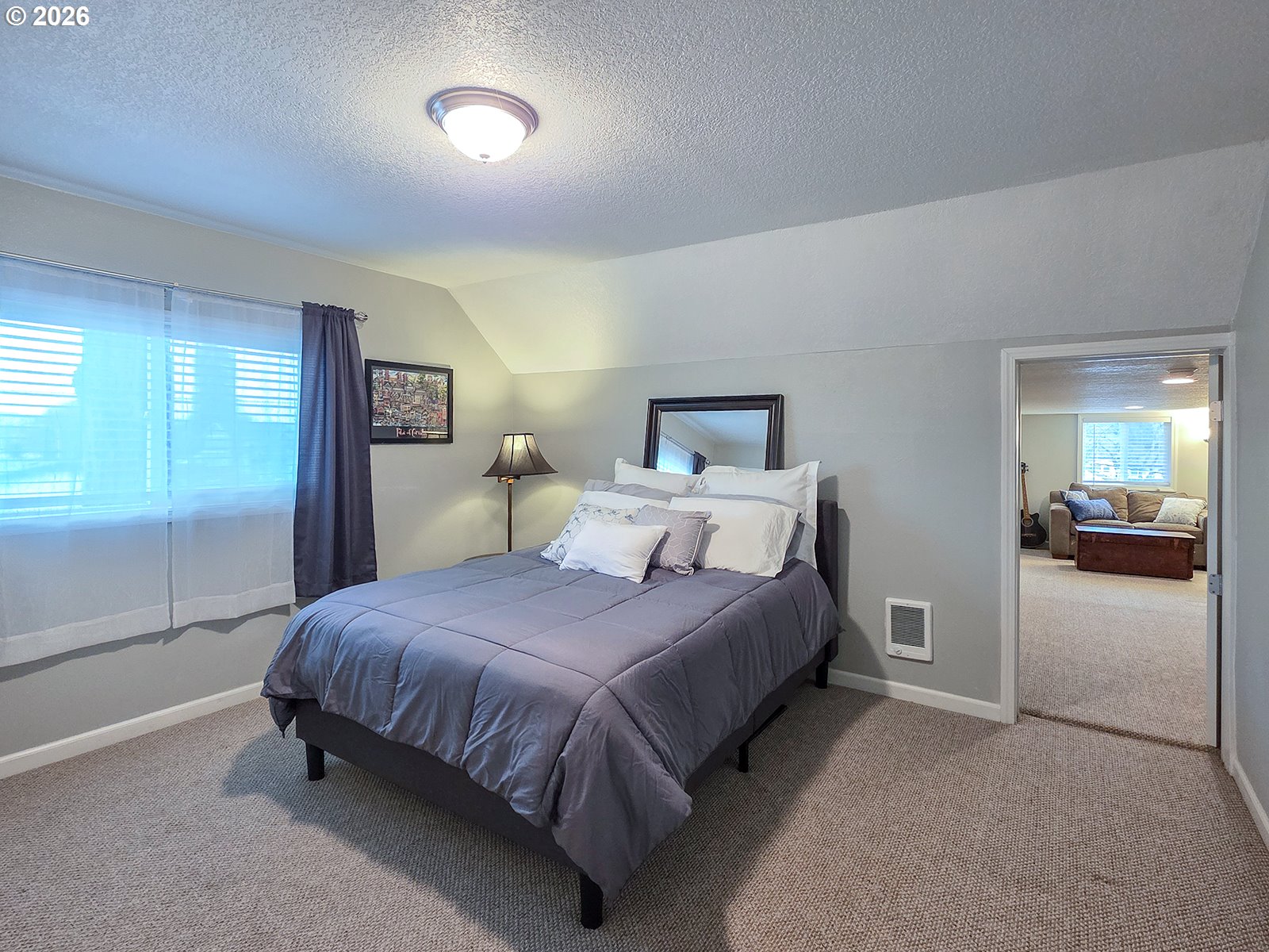 1214 North Clark Street Cornelius, OR 97113 - Photo 23 of 34 a bedroom with a bed and a lamp