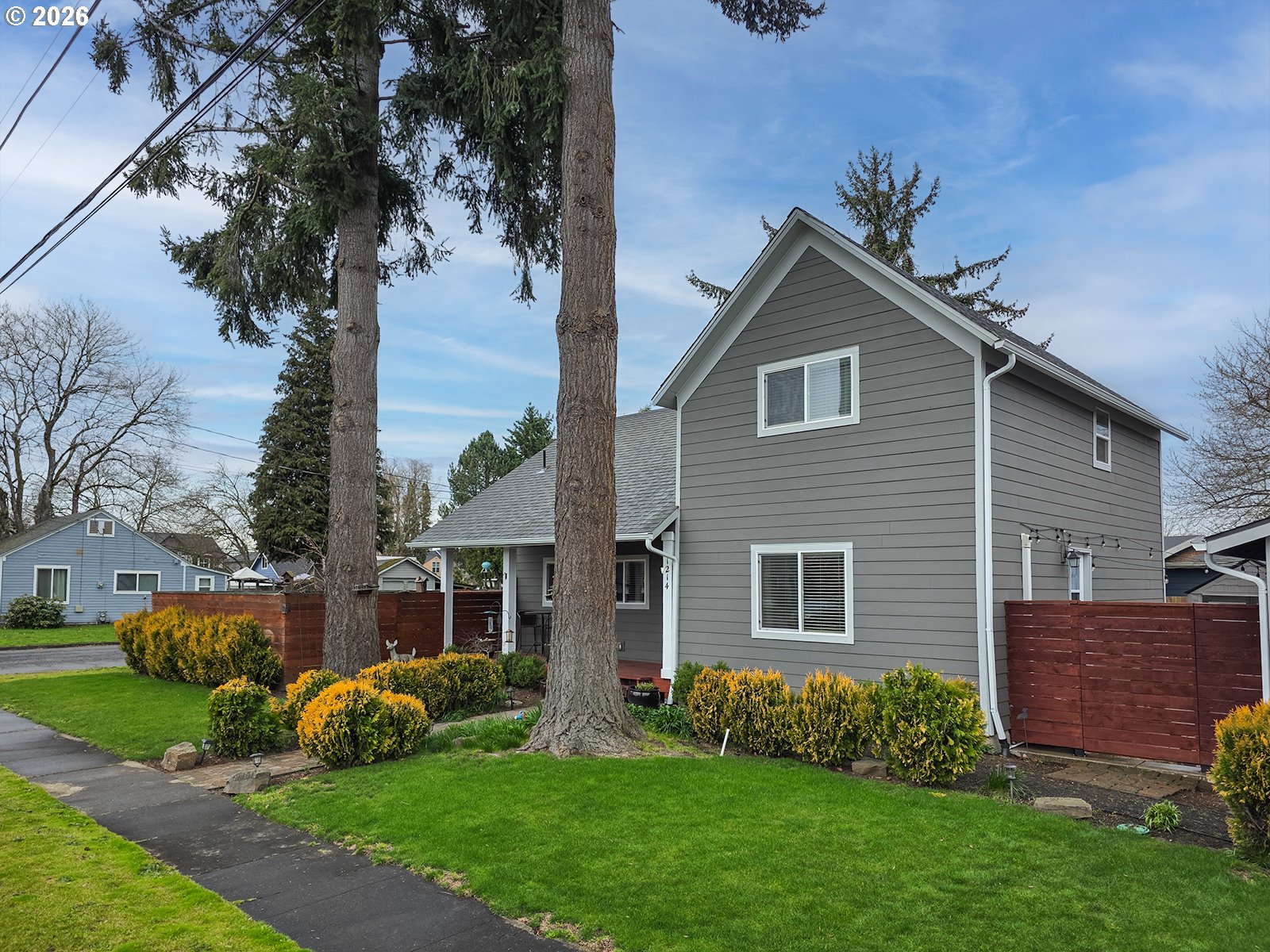 1214 North Clark Street Cornelius, OR 97113 - Photo 7 of 34 a front view of a house with a garden and yard