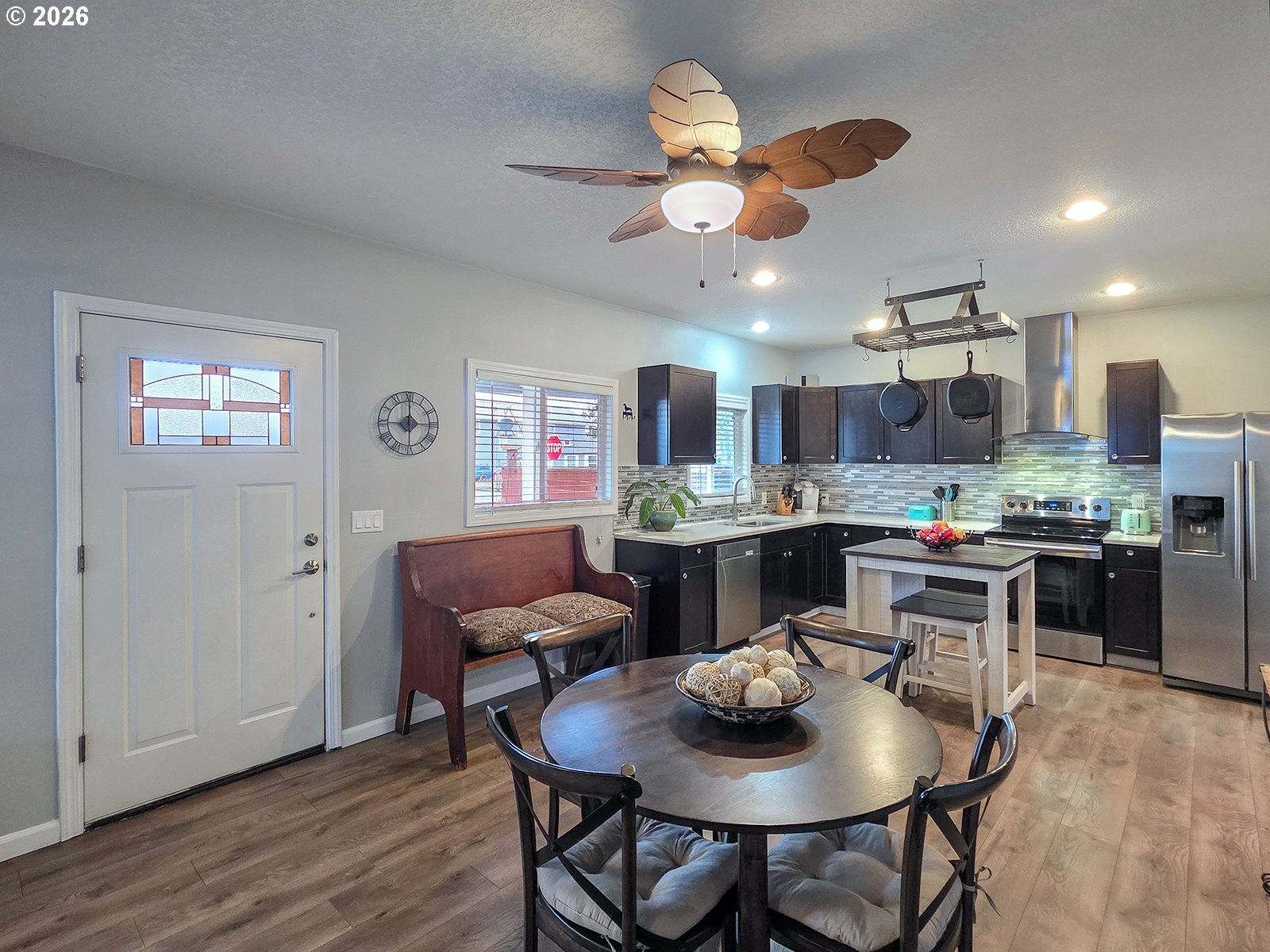 1214 North Clark Street Cornelius, OR 97113 - Photo 10 of 34 a kitchen with a dining table cabinets stainless steel appliances and a chandelier