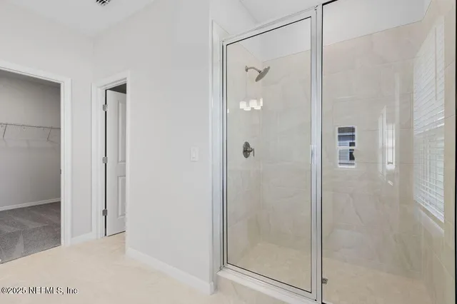 a bathroom with a glass shower door