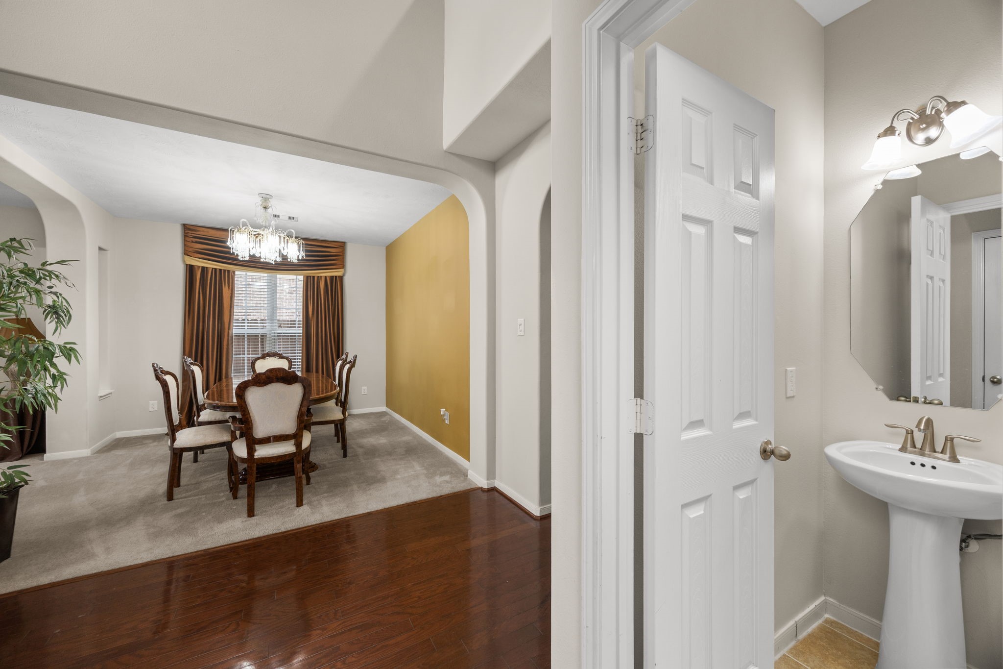 6719 Latchmore Lane Houston, TX 77049 - Photo 24 of 46 a view of a a dining room with furniture window and wooden floor