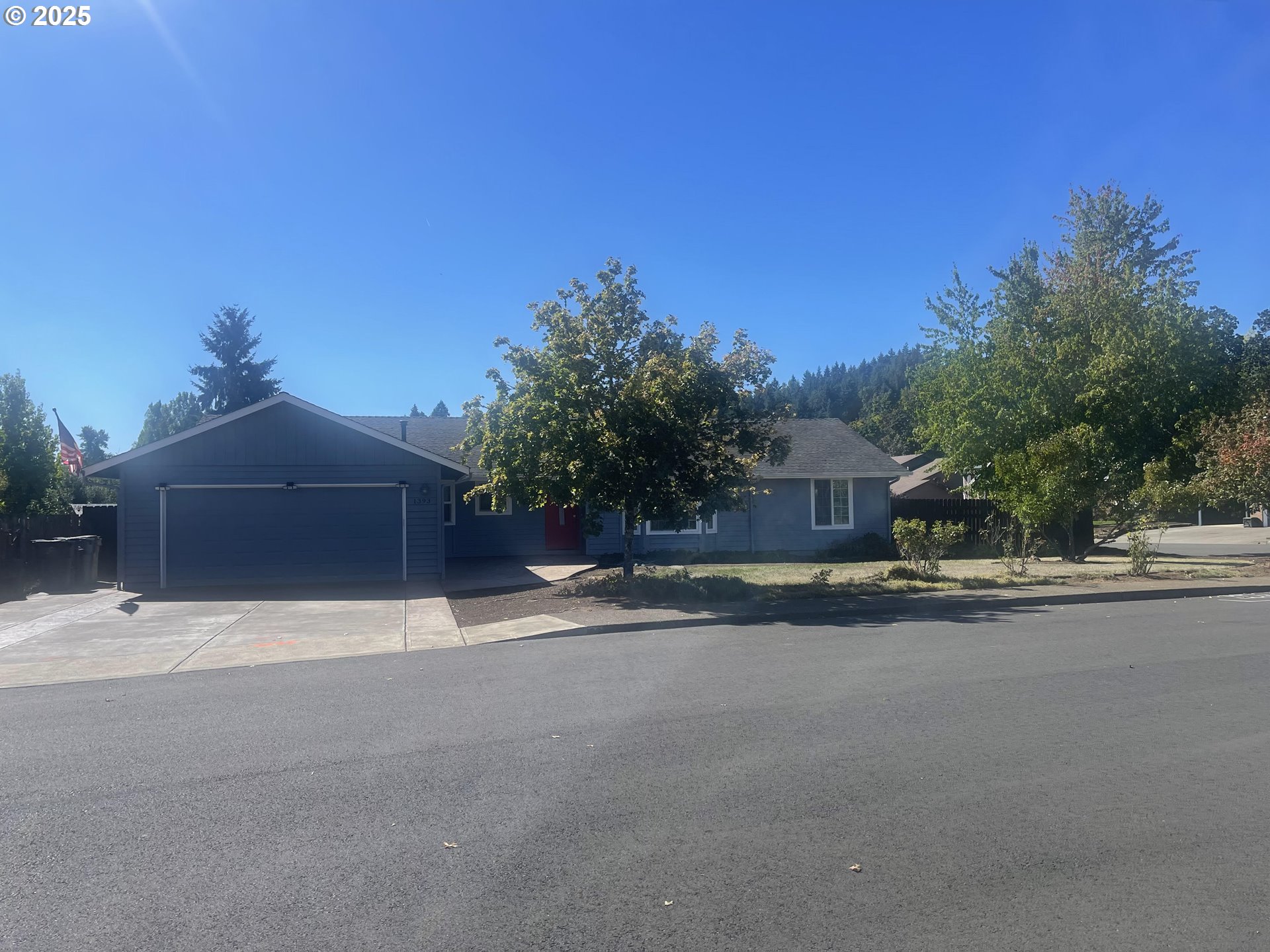 1393 Southwest Alexander Drive Dallas, OR 97338 - Photo 1 of 47 a front view of a house with a yard and garage