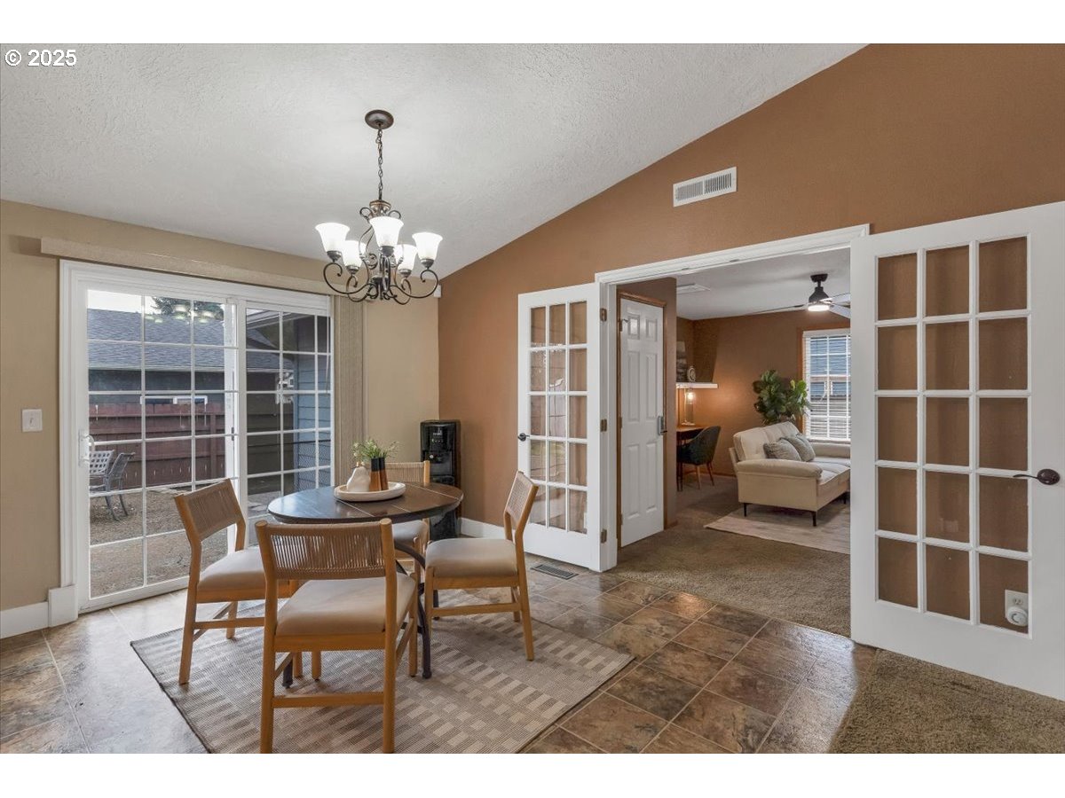 1393 Southwest Alexander Drive Dallas, OR 97338 - Photo 13 of 47 a living room with furniture and a chandelier