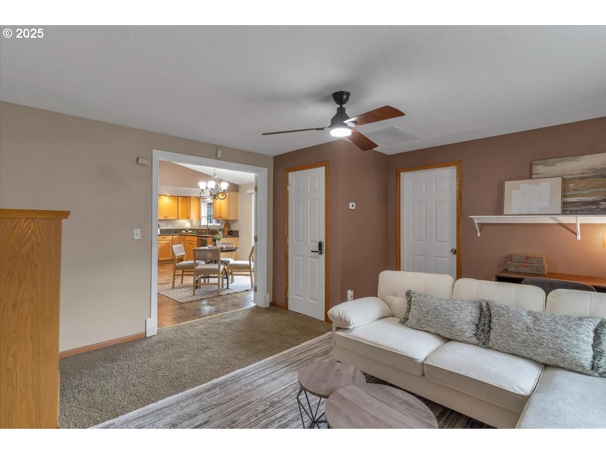1393 Southwest Alexander Drive Dallas, OR 97338 - Photo 25 of 47 a living room with furniture and a chandelier