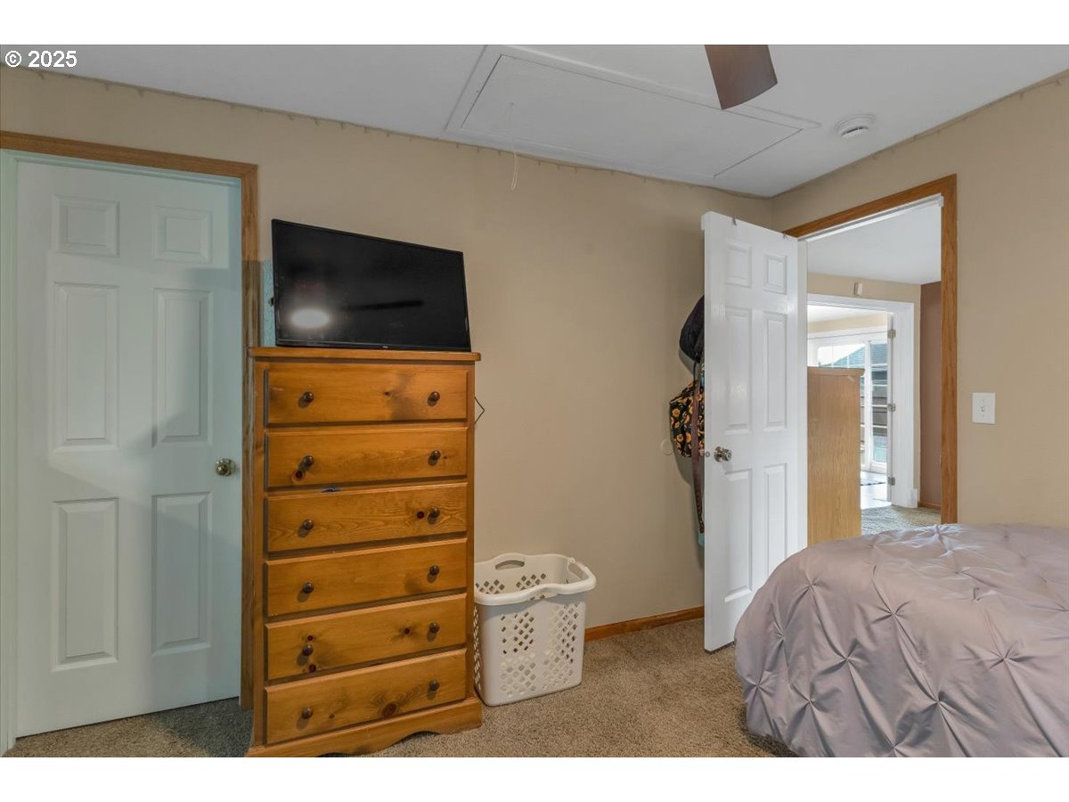 1393 Southwest Alexander Drive Dallas, OR 97338 - Photo 27 of 47 a bedroom with a bed and a television