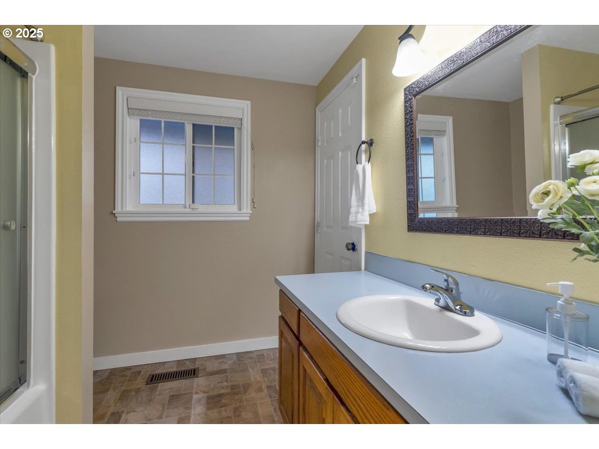 1393 Southwest Alexander Drive Dallas, OR 97338 - Photo 30 of 47 a bathroom with a sink and a mirror