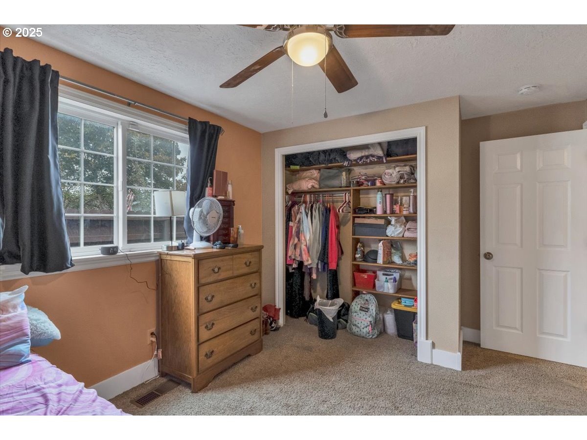 1393 Southwest Alexander Drive Dallas, OR 97338 - Photo 34 of 47 a view of walk in closet with clothes and shoes