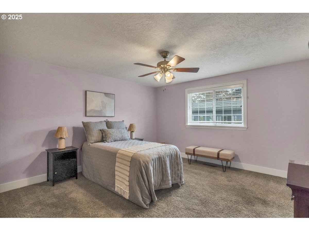 1393 Southwest Alexander Drive Dallas, OR 97338 - Photo 35 of 47 a bedroom with a bed chandelier and a window