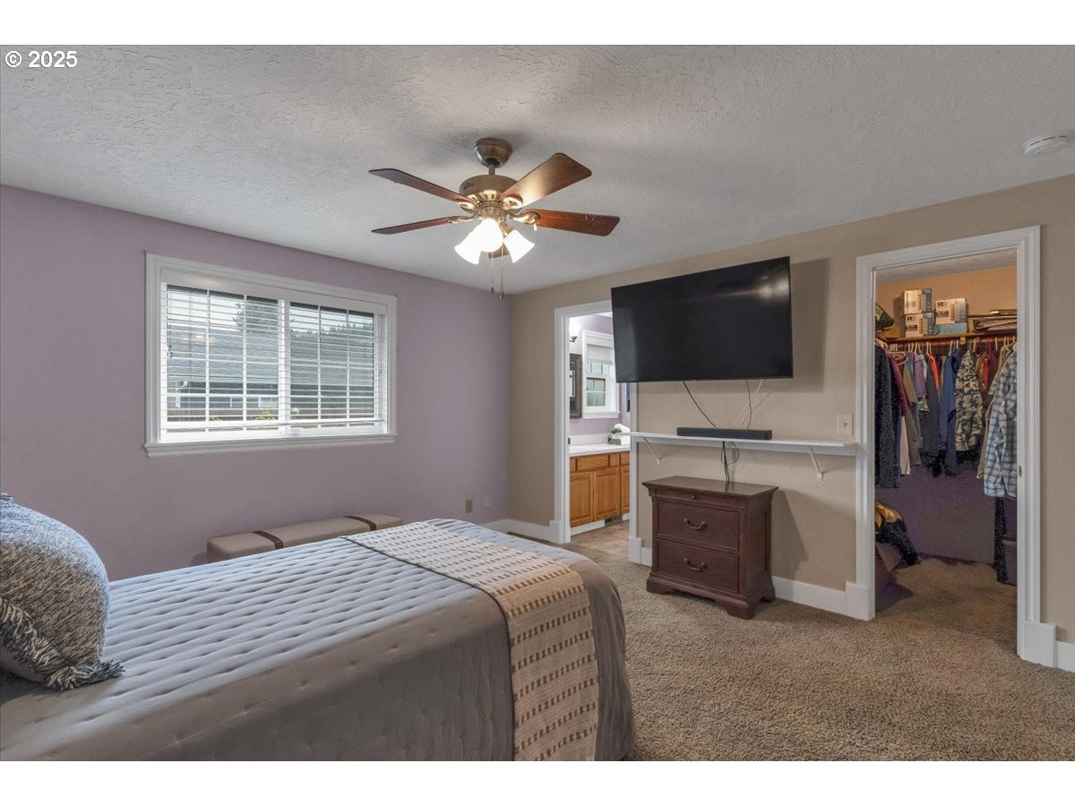 1393 Southwest Alexander Drive Dallas, OR 97338 - Photo 36 of 47 a bedroom with a bed and a flat screen tv