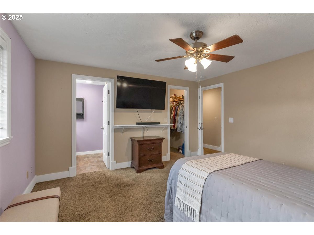 1393 Southwest Alexander Drive Dallas, OR 97338 - Photo 37 of 47 a bedroom with a bed and a flat screen tv