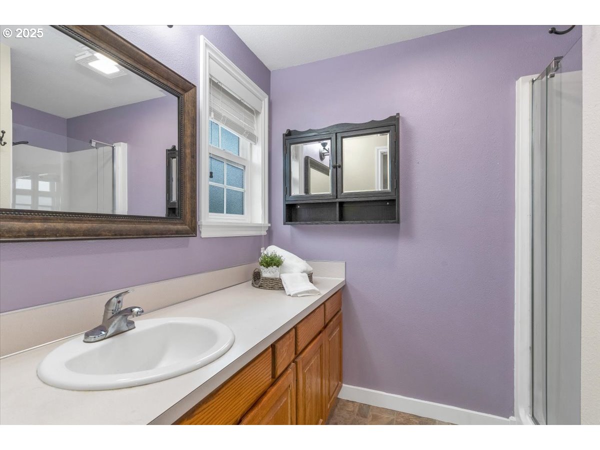 1393 Southwest Alexander Drive Dallas, OR 97338 - Photo 38 of 47 a bathroom with a sink mirror and vanity