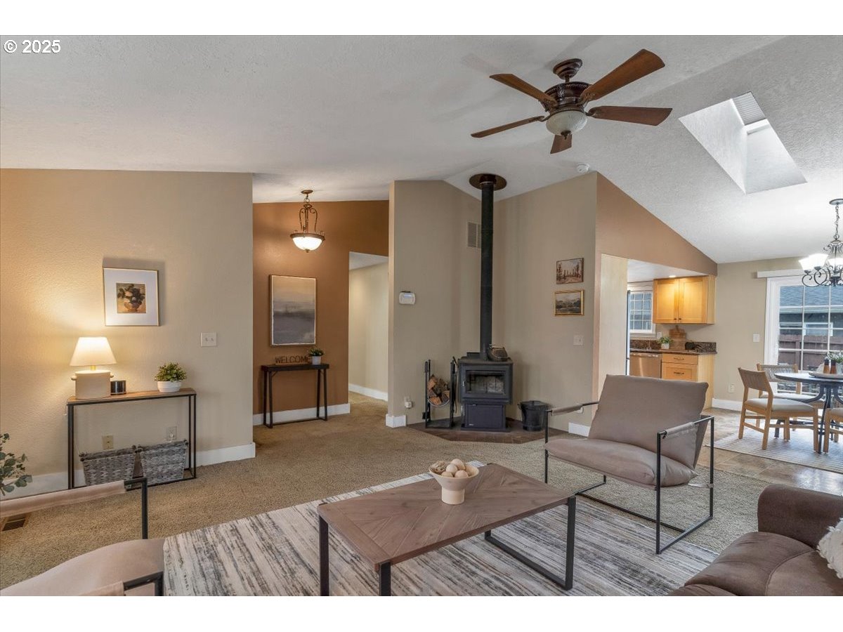 1393 Southwest Alexander Drive Dallas, OR 97338 - Photo 10 of 47 a living room with furniture and a chandelier