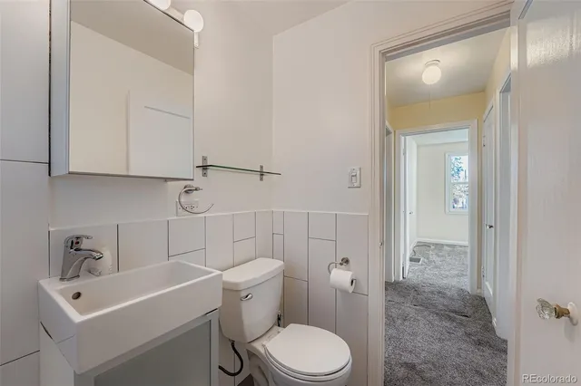 a white toilet sitting next to a bathroom sink