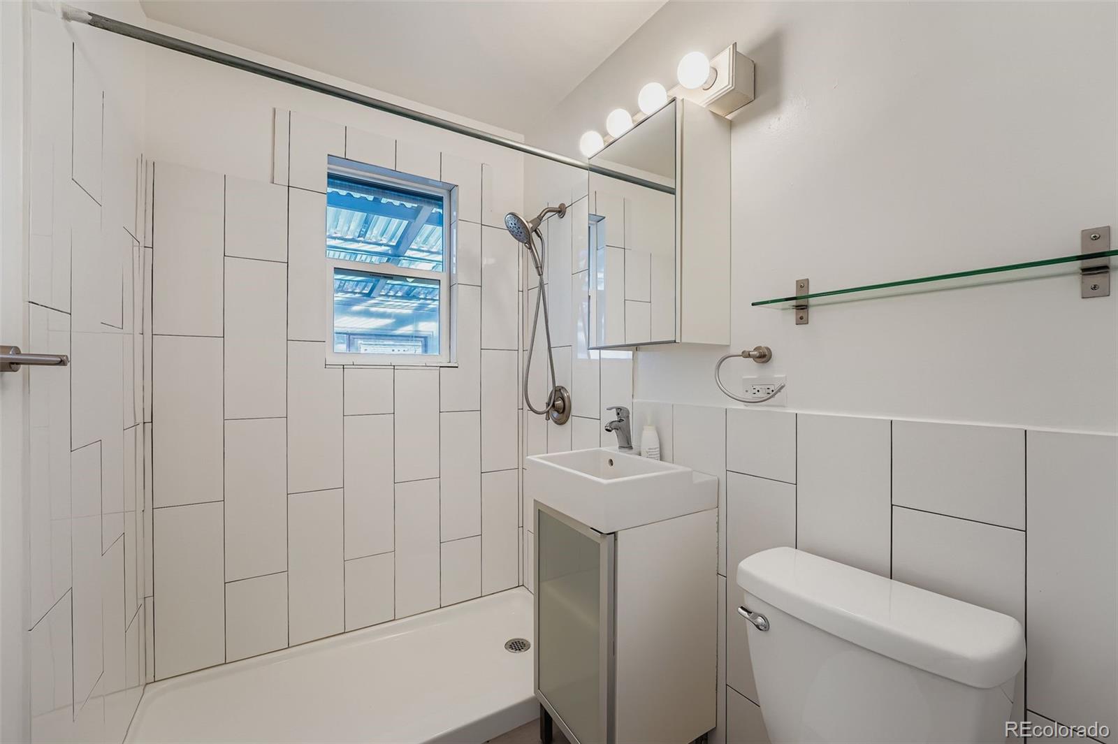 3630 Fillmore Street Denver, CO 80205 - Photo 15 of 50 a bathroom with a toilet sink shower and mirror