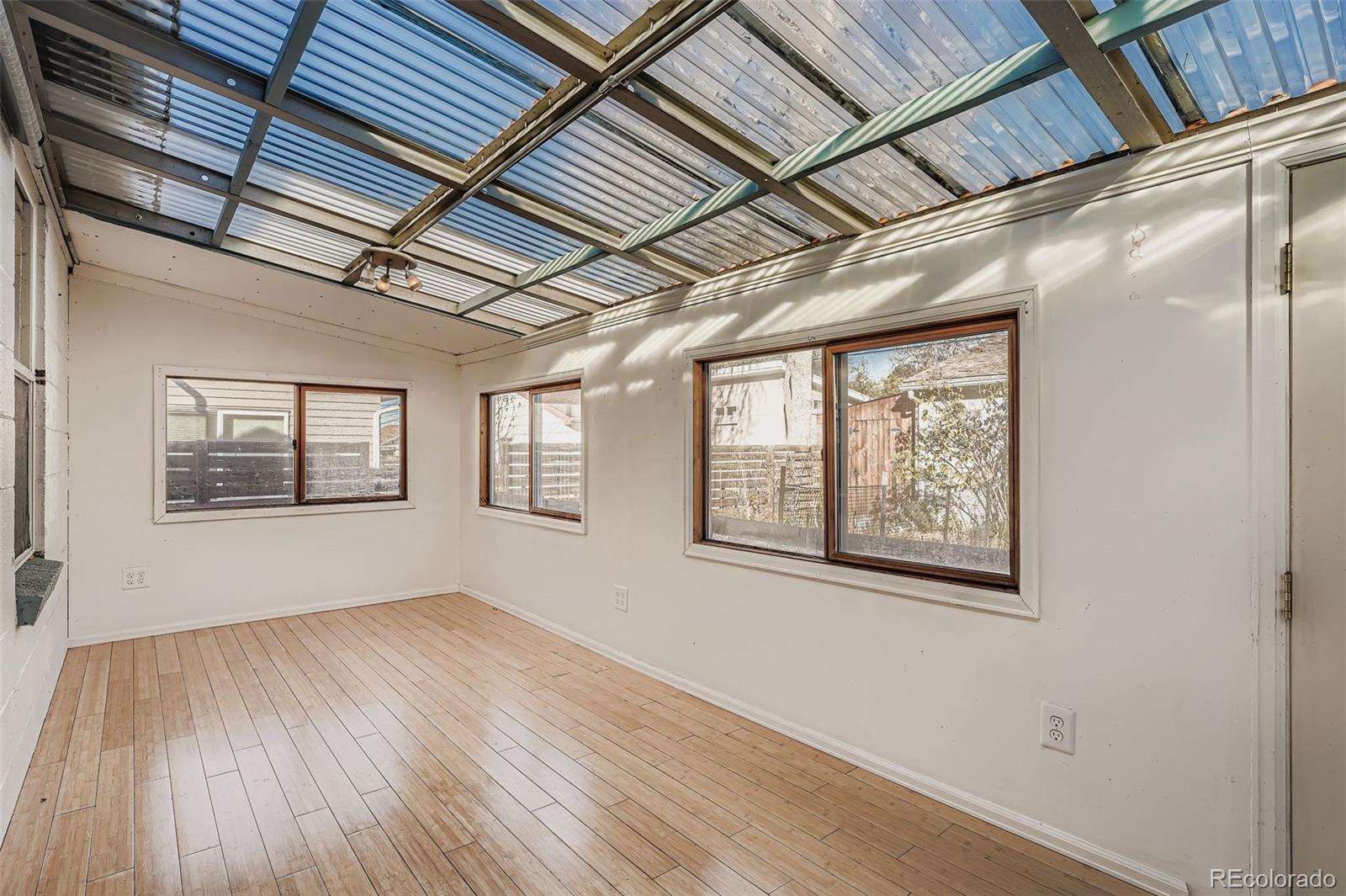 3630 Fillmore Street Denver, CO 80205 - Photo 20 of 50 a view of an empty room with wooden floor and a window