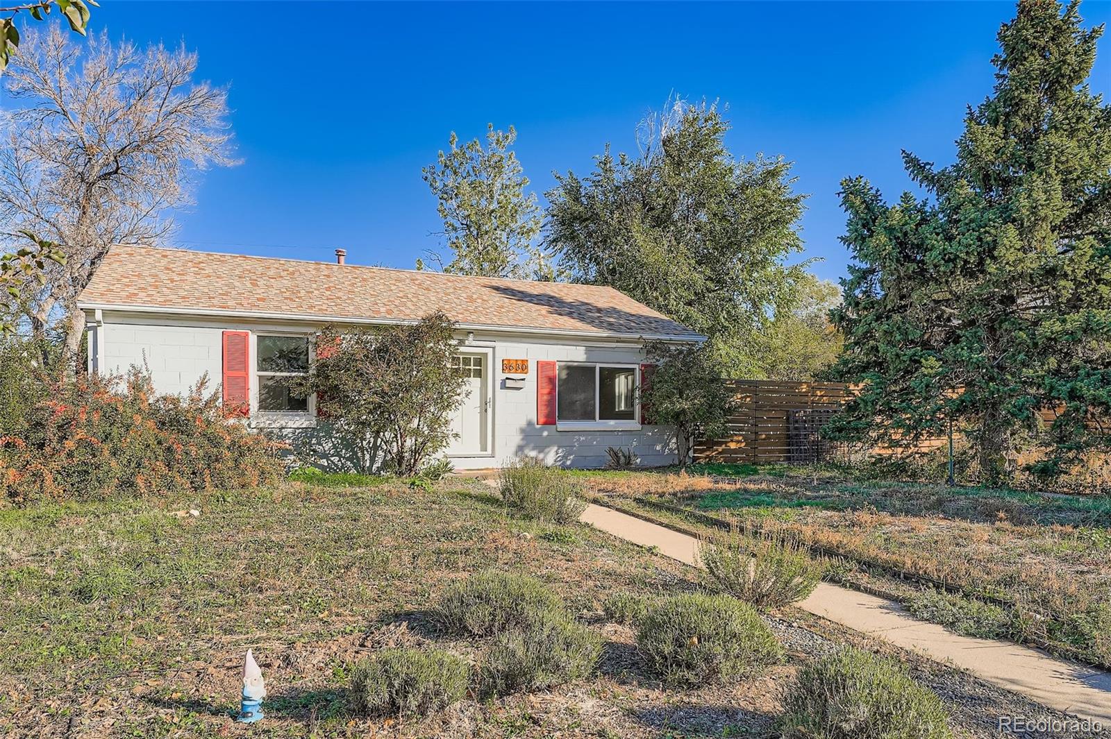 3630 Fillmore Street Denver, CO 80205 - Photo 2 of 50 a front view of a house with a yard