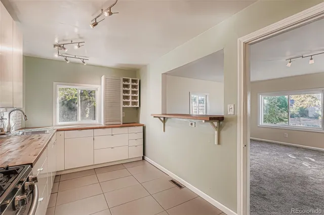 a view of a kitchen with a sink and dishwasher cabinet with wooden floor