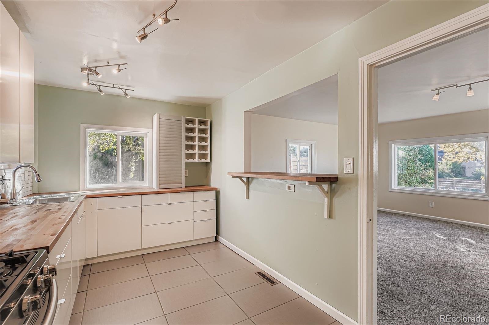 3630 Fillmore Street Denver, CO 80205 - Photo 4 of 50 a view of a kitchen with a sink and dishwasher cabinet with wooden floor