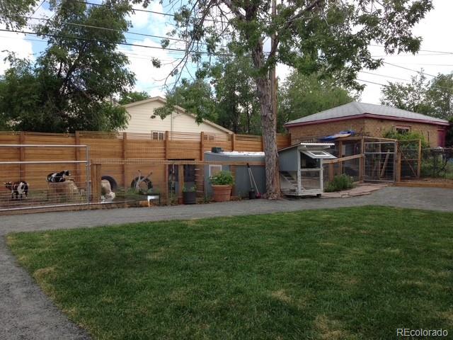 3630 Fillmore Street Denver, CO 80205 - Photo 6 of 50 a view of a yard with a table and chairs under an umbrella