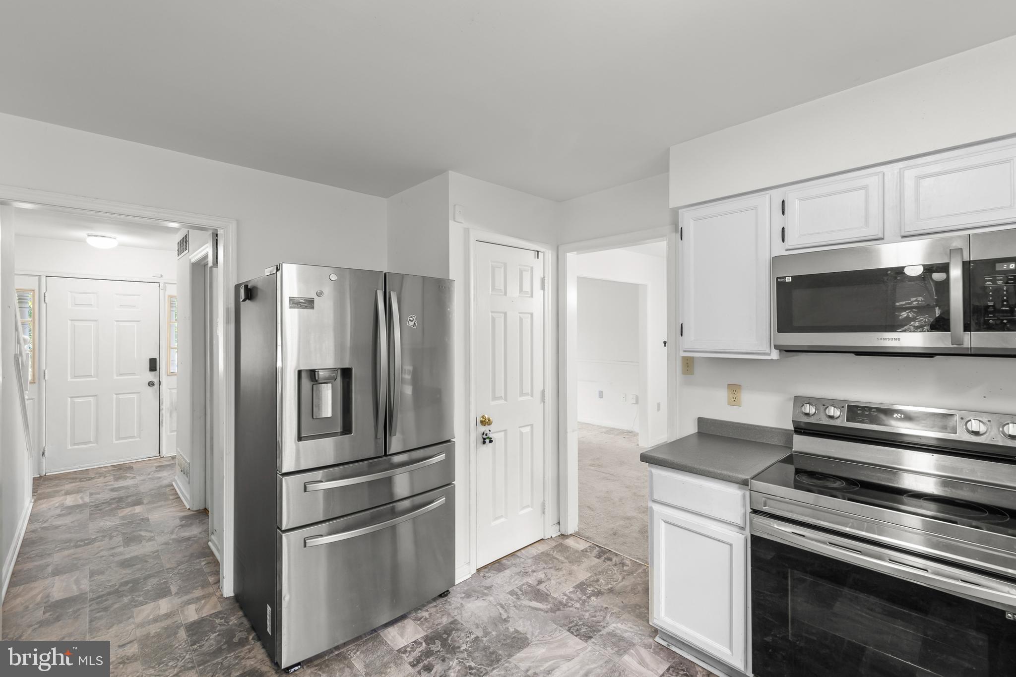 a kitchen with stainless steel appliances and refrigerator