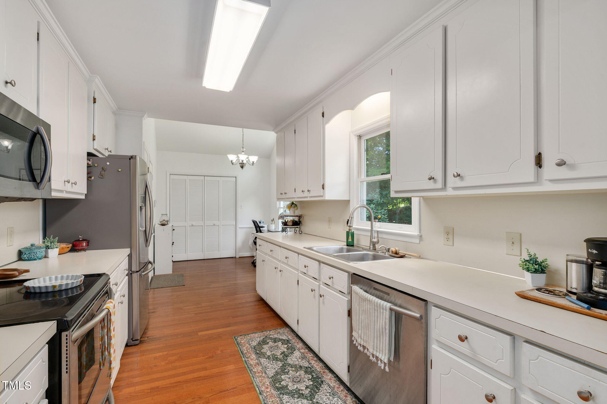 5320 Middleton Road Durham, NC 27713 - Photo 12 of 36 a kitchen with stainless steel appliances granite countertop a sink stove and refrigerator