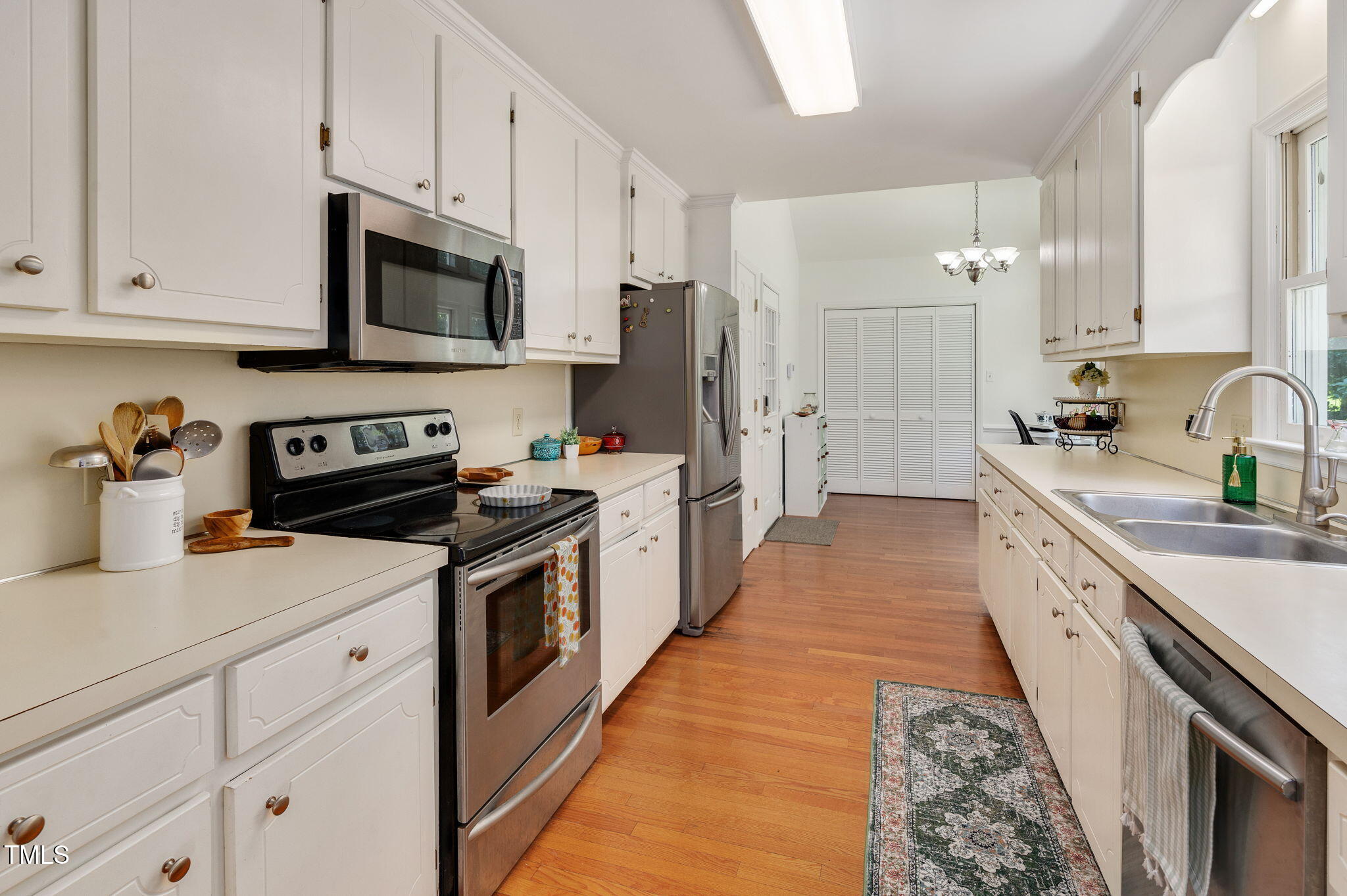 5320 Middleton Road Durham, NC 27713 - Photo 15 of 36 a kitchen with stainless steel appliances a sink stove and white cabinets