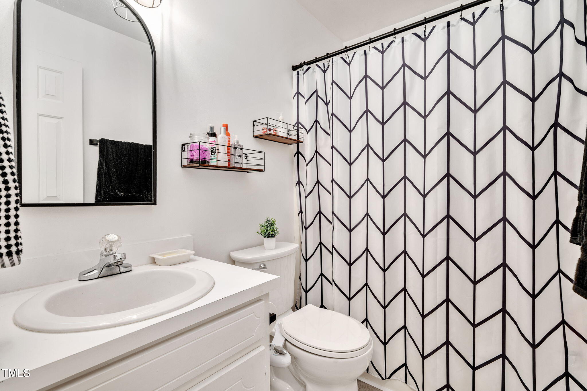 5320 Middleton Road Durham, NC 27713 - Photo 27 of 36 a bathroom with a sink vanity mirror and toilet