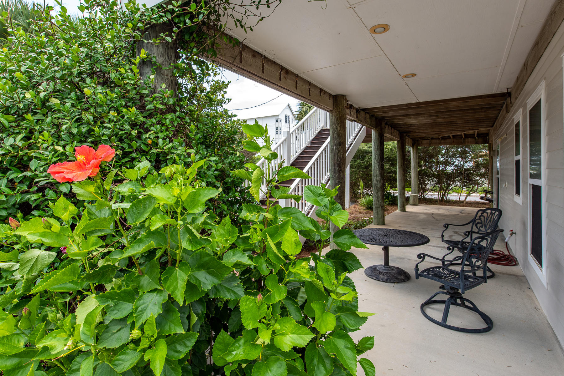 278 Pompano Street Inlet Beach, FL 32461 - Photo 54 of 57 a view of a chair and tables in the back yard