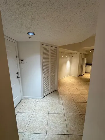 a view of a livingroom with wooden floor and a bathroom