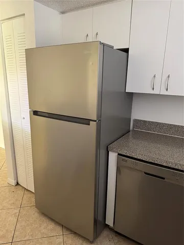 a white refrigerator freezer sitting in a kitchen