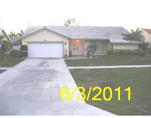 7689 West Country Club Boulevard Boca Raton, FL 33487 - Photo 1 of 1 a front view of a house with a yard