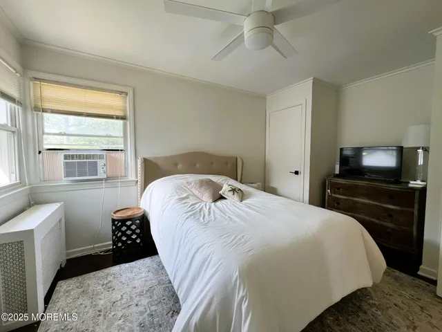 a bedroom with a bed and a television