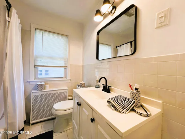 a bathroom with a sink a mirror and a toilet