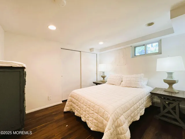 a bedroom with a bed and a night stand