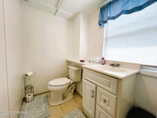 a bathroom with a sink toilet and a mirror