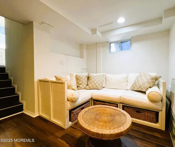 a living room with furniture a couch and wooden floor