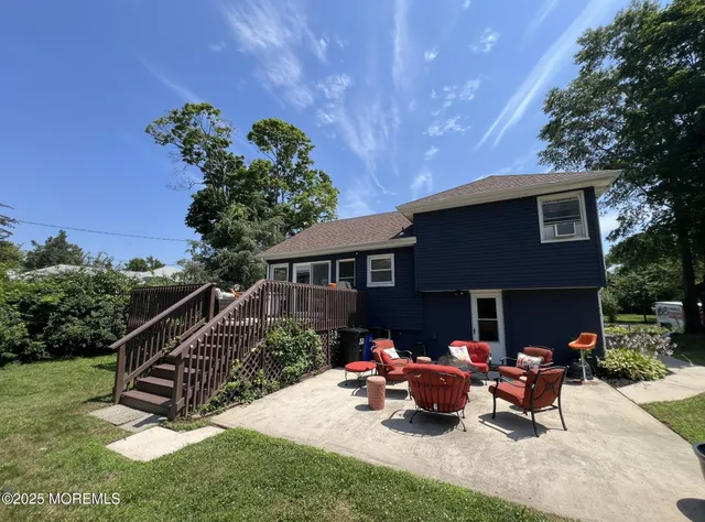 a view of a house with backyard and sitting area