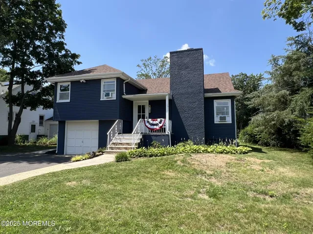 a brick house with a yard in front of it