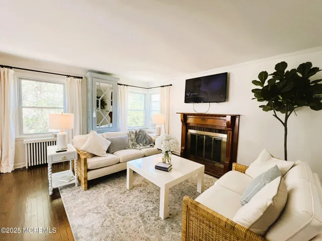 a living room with furniture fireplace and a flat screen tv