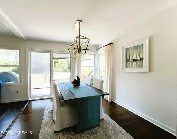 a dining room with table windows and wooden floor
