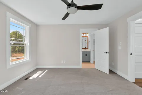 a bathroom with a toilet a sink a mirror and shower