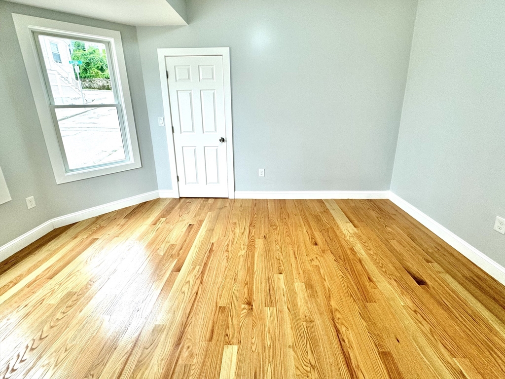 190 Hillside Street, Unit 1 Boston, MA 02120 - Photo 12 of 27 a view of a room with wooden floor and windows