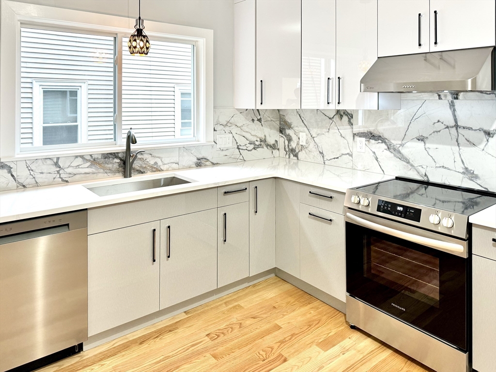 190 Hillside Street, Unit 1 Boston, MA 02120 - Photo 19 of 27 a kitchen with granite countertop a sink stainless steel appliances and cabinets